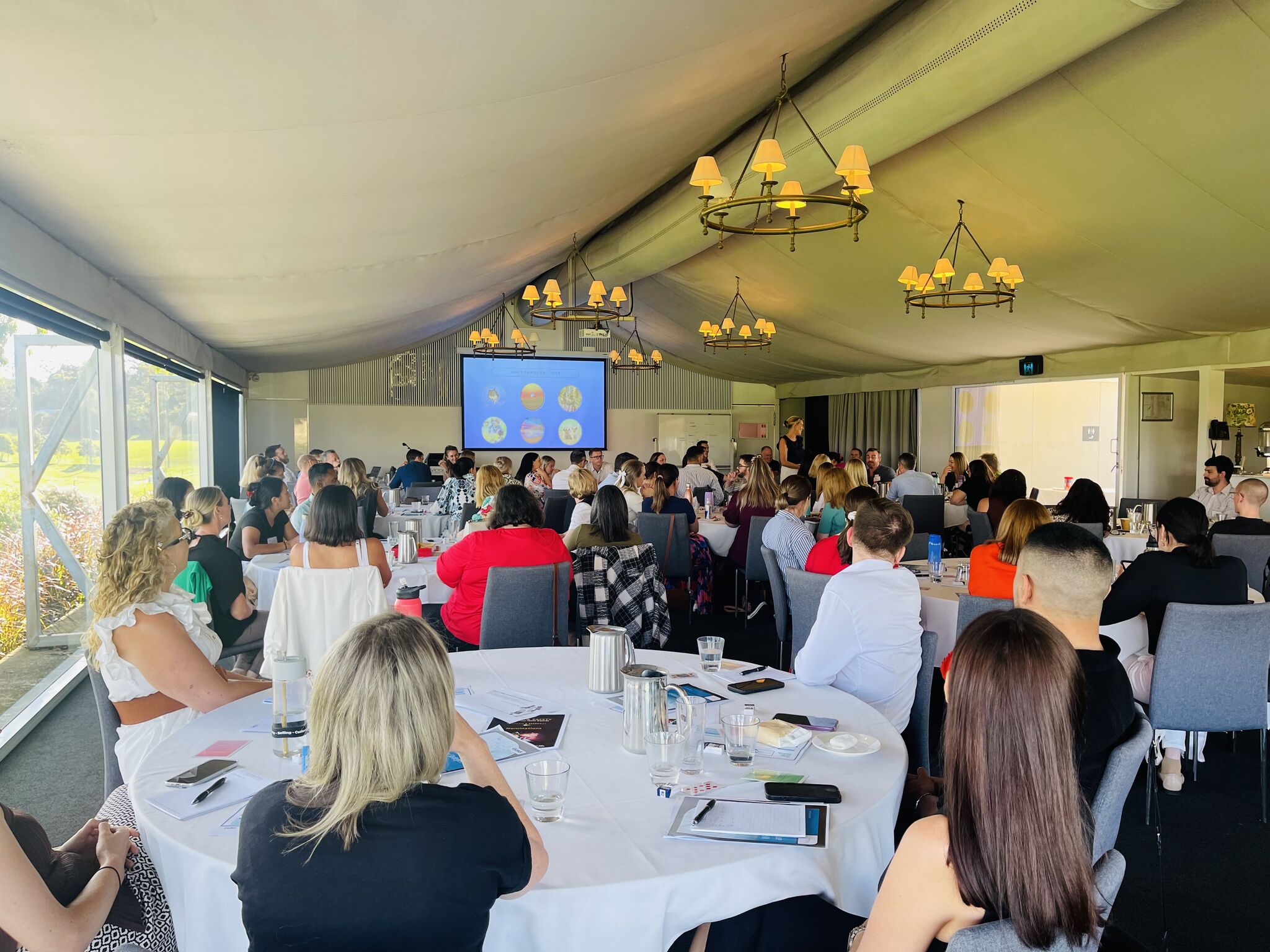 Camilla presenting at corporate event in marquee